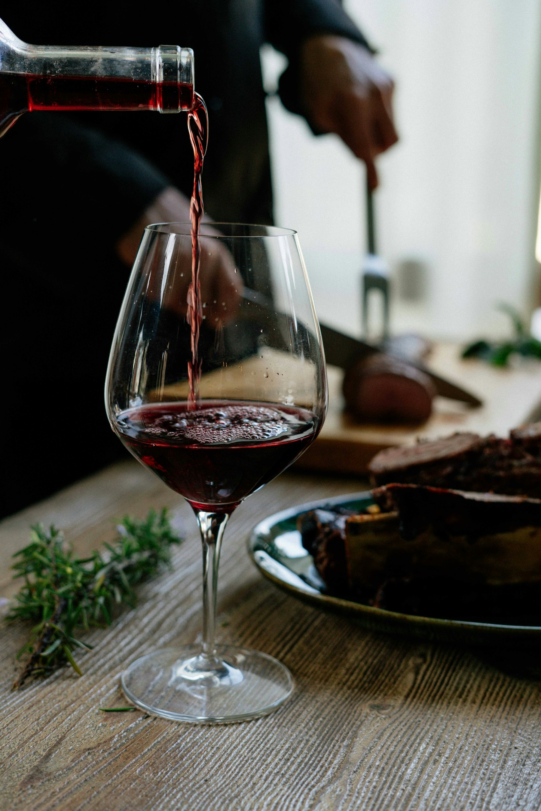 A glass of red being poured